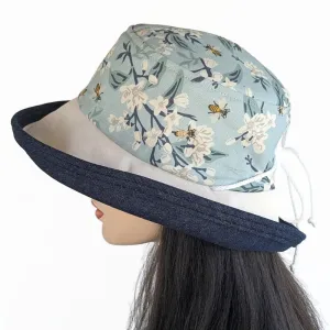 Sunblocker UV sun hat with large wide bucket brim, featuring bees in blues, adjustable fit