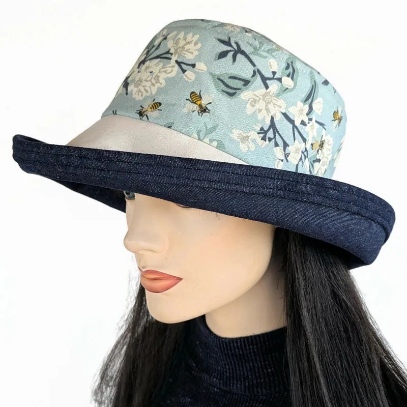 Sunblocker UV sun hat with large wide bucket brim, featuring bees in blues, adjustable fit